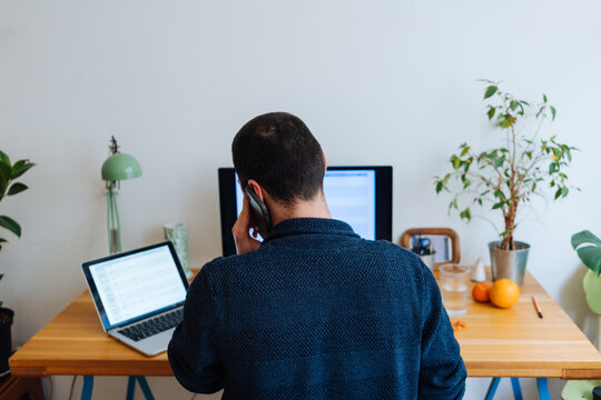 Unrecognizable Adult Man Talking On The Phone.