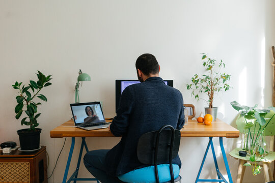 Young adult man having a business video call conversation 