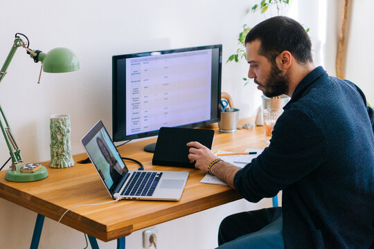 Young adult man having a business video call conversation 