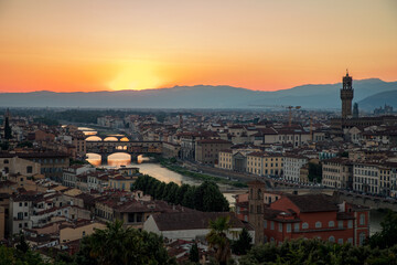 Fototapeta na wymiar Florence, Italy -20 June, 2019 : panorama of the city at twilight, view from Piazzale Michelangelo to river Arno, numerous bridges and historical part of the city