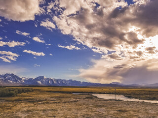 Arid plains against Sierra Nevada Mountains and clear blue sky 