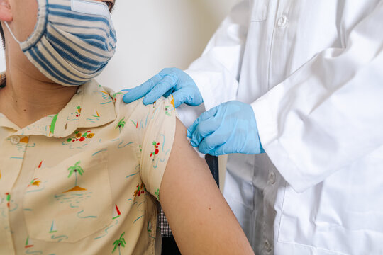 Crop Doctor disinfecting arm of patient before injection