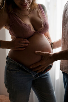 Pregnant woman at home with boyfriend