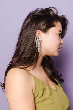 Portrait of a woman in green dress with an ear cuff