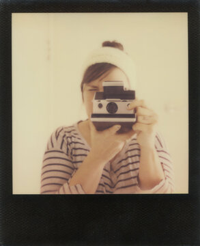 Young Woman With Polaroid Camera