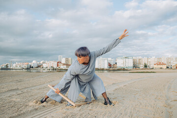 Female dancer performing on the sand 