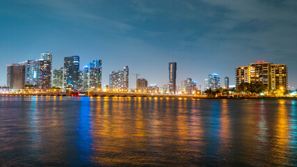 Fototapeta premium Miami city. Miami skyline panorama at dusk with skyscrapers over sea. Night downtown sanset.