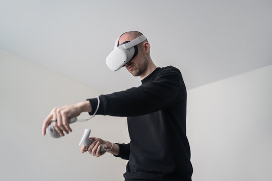 Man in VR headset playing videogame