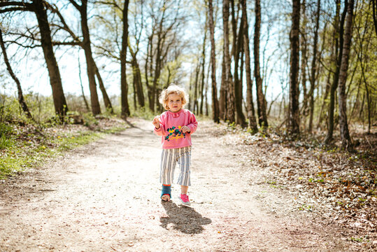 Little blond girl in the forest
