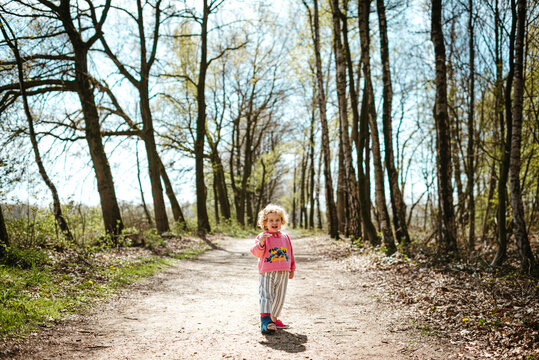 Little blond girl in the forest
