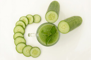 closeup sliced green ripe cucumber with juice isolated on white background.