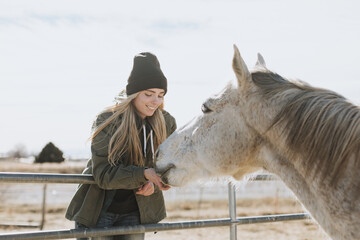 Rancher Feeding A Horse Carrots