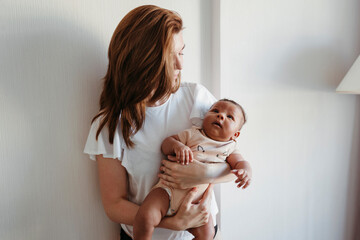 Young mother with her newborn baby.