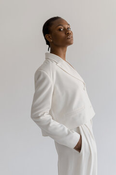 Trendy Black Woman In white suit In Studio