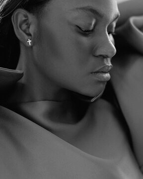 Trendy Black Woman wearing a brown blouse in Studio 