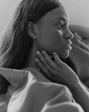 Trendy Black Woman wearing a brown blouse in Studio