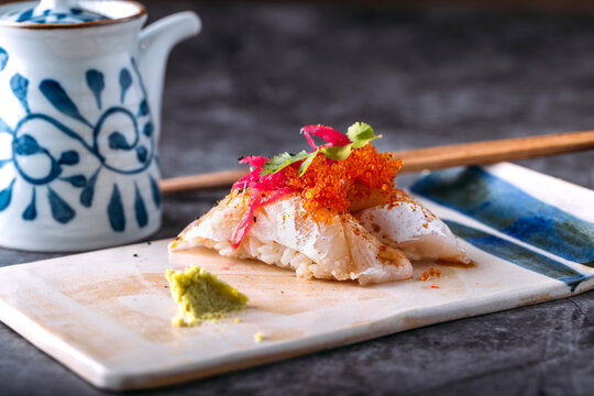 Tasty sushi with fish and tobiko on table