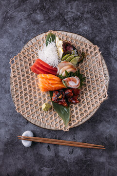 Tasty Sashimi on banana leaf on table