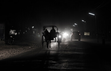 Horse carriage silhouette of a person walking on the road, Bagan, Myanmar