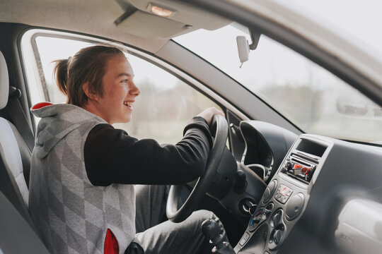 A Young Happy Man In A Car