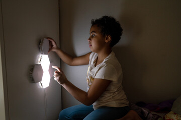 Girl touches hexagon lamp