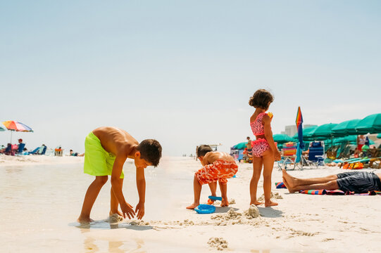Family relaxing on the beach. 