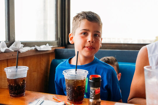 Boy sitting at a booth. 
