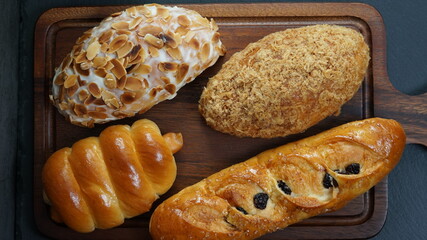bread and buns on wooden board