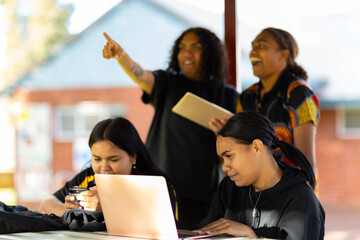 group of students outside with digital devices