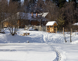 Winter season, snow-covered recreation center in the snow captivity of nature, early frosty morning with sparkling snow.