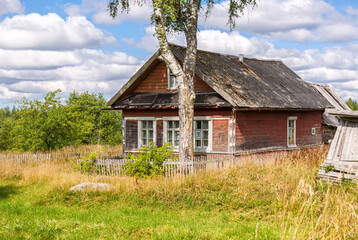 Fototapeta na wymiar Old rural wooden houses in abandoned russian village