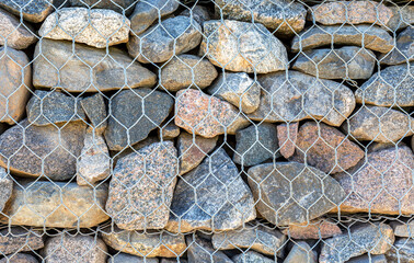 Stone wall with metal grid as background