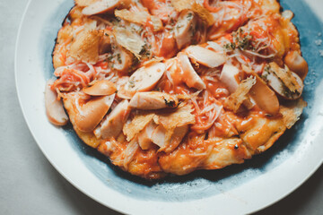 Tasty hot homemade pizza with hotdog and crab sticks with cheese.