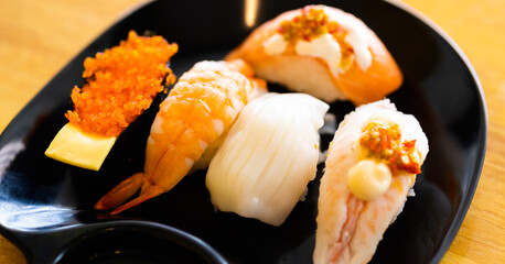 Various toppings of delicious sushi are placed on plates in Japanese restaurants. It is a very popular dish of Japan.
