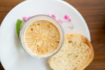 Dirty coffee cup (espresso coffee with milk) served with bread crispy