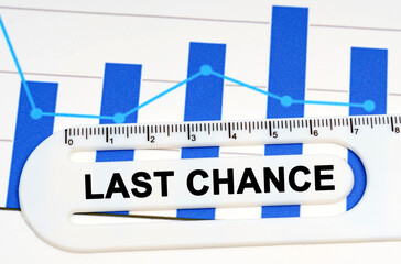On the sheet with graphs there is a white ruler with the inscription - LAST CHANCE