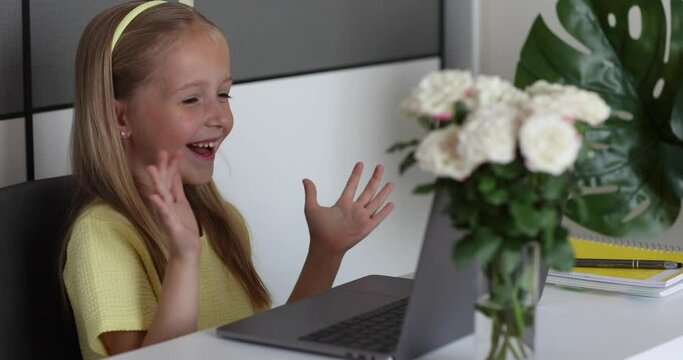Caucasian little girl school pupil studying online from home, watching web class lesson or listening tutor by video call elearning during coronavirus covid-19 pandemic self isolation. Slow motion