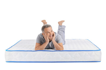 Mature man lying on soft mattress against white background