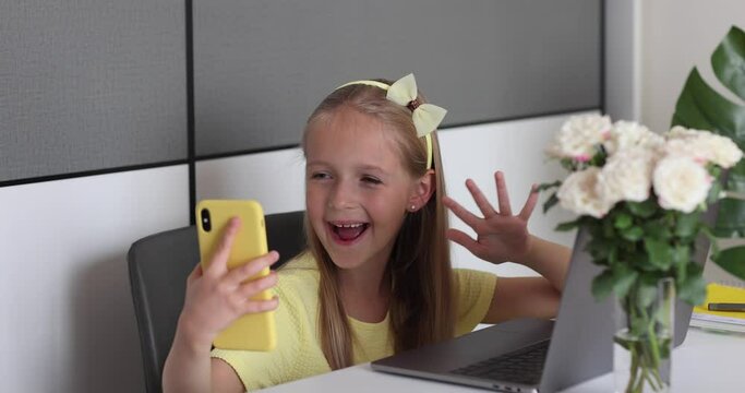 Caucasian little girl school pupil studying online from home, watching web class lesson or listening tutor by video call elearning during coronavirus covid-19 pandemic self isolation. Slow motion