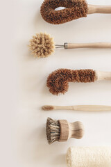 Zero waste kitchen cleaning concept. Eco friendly natural cleaning tools and products, bamboo dish brushes. No plastic, eco-friendly lifestyle. Top view, flat lay.