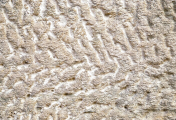 The texture of the plaster on the wall. Uneven and rough surface of gray color.