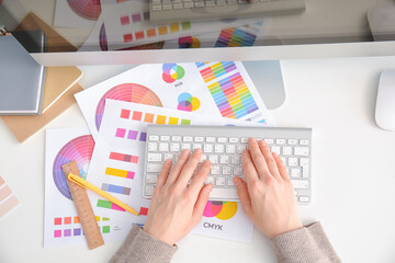Fototapeta premium Female designer working in office, top view