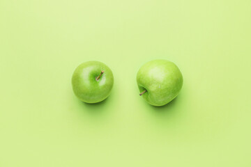 Fresh green apples on color background