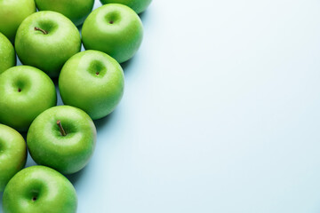 Fresh green apples on color background