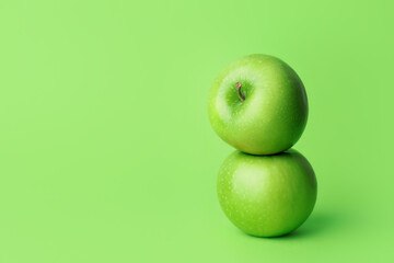 Fresh green apples on color background