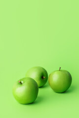 Fresh green apples on color background
