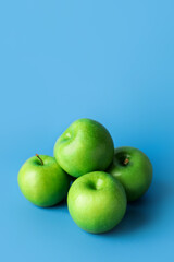 Fresh green apples on color background