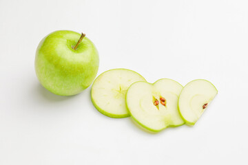 Fresh green apple with slices on white background