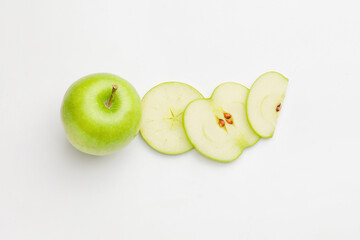 Fresh green apple with slices on white background