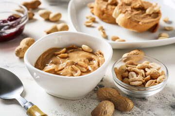 Bowl with tasty peanut butter on table
